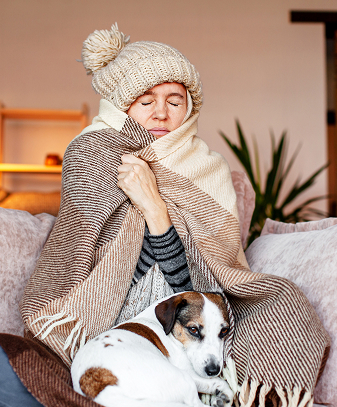 Woman wrapped in a blanket, covering her body and appearing warm and comfortable.