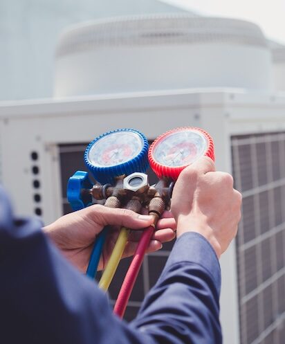 Technician is checking air conditioner ,measuring equipment for filling air conditioners.